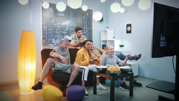 Multi-ethnic Friends Falling Down on Sofa To Watch TV alt