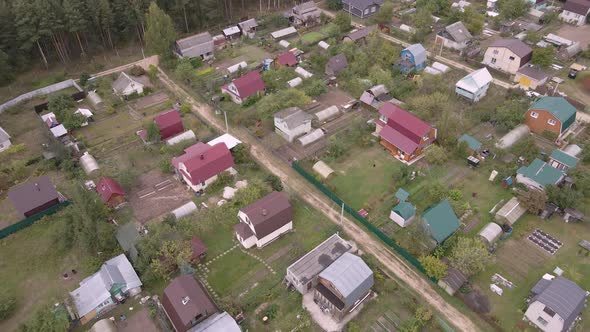 Aerial View of the Countryside with Small Garden Houses and Dirt Roads alt