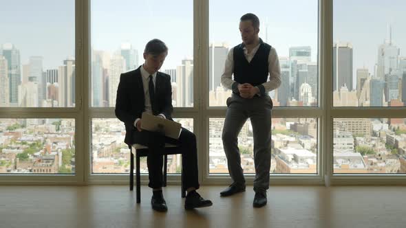 Two Young Businessman Meeting Talking Together about Financial Business Idea Plan alt