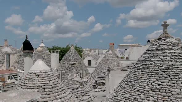 Aerial shot in Alberobello, a beautiful touristic city in the region of Apulia (South Italy) with tr alt