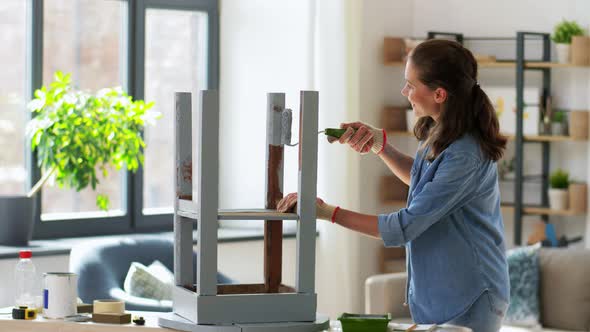 Woman Painting Old Wooden Table with Grey Color alt