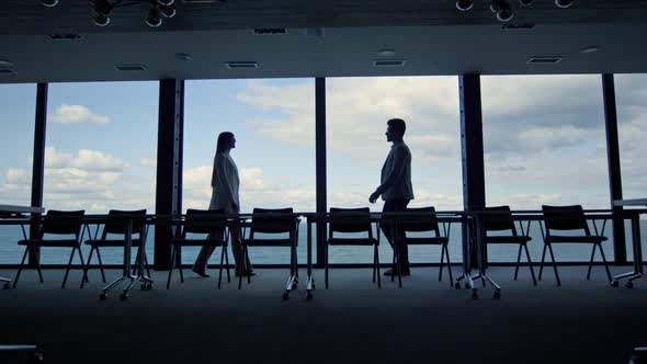 Business Silhouettes Meeting Shaking Hands at Office Panorama Window View alt