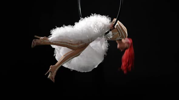 Wide Shot Young Slim Redhead Woman in Costume Hopping Down From Air Hoop Walking Away alt