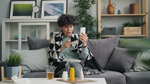 Young Lady Skyping Talking To Doctor Using Smartphone Discussing Treatment alt