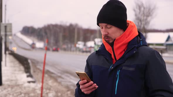 A Business Man with a Mustache Makes a Purchase on a Smartphone alt