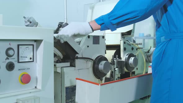 close up worker male hand manage machinery Side View Automatic Thin Metal Threads Reeled alt