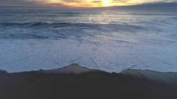 Golden Sunset Obove the Sea or Ocean. Foamy Waves Rolling the Waters of the Sea alt