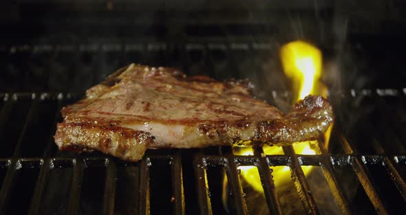 T-Bone Steak On Barbecue Grill Flames 44b