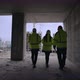 Civil Engineers are Walking in Building Under Construction Rear View of Female and Male Professional - VideoHive Item for Sale