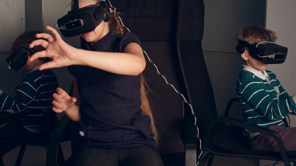 Three little kids in vr headsets enjoying virtual reality game