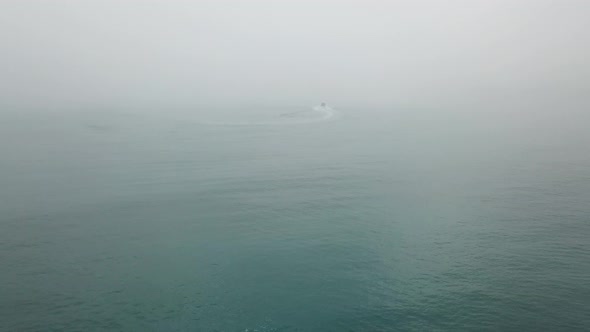 Aerial view a boat leave in the misty sea  alt