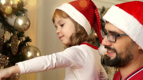 Father with Girl Decorate Christmas Tree