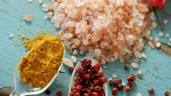 Various spices on wooden table 4k alt