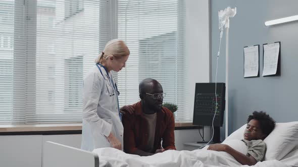 Doctor Reassuring Dad of Sick Son alt