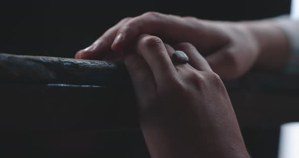 Young woman resting hands on table top close up alt