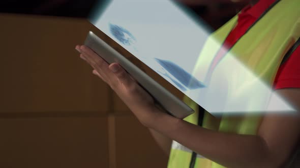 warehouse workers using tablets to discuss holograms 