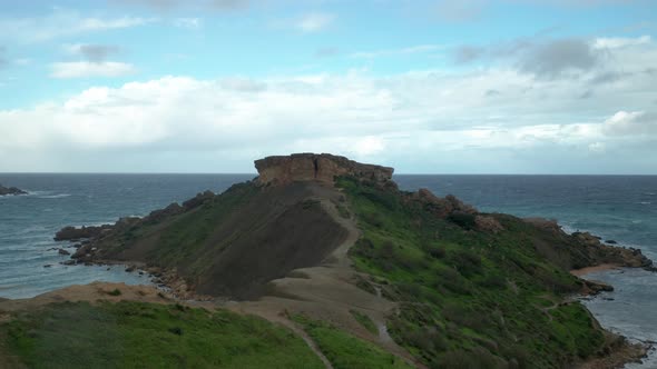 AERIAL: Il-Qarraba Mountain in Malta During Cloudy and Windy Day in Malta alt