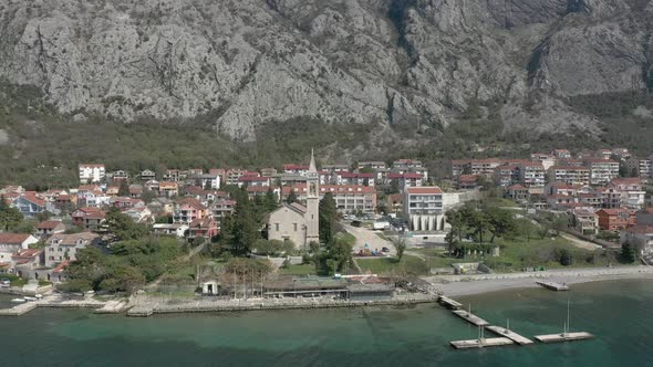 Flying from open sea towards a coastal town