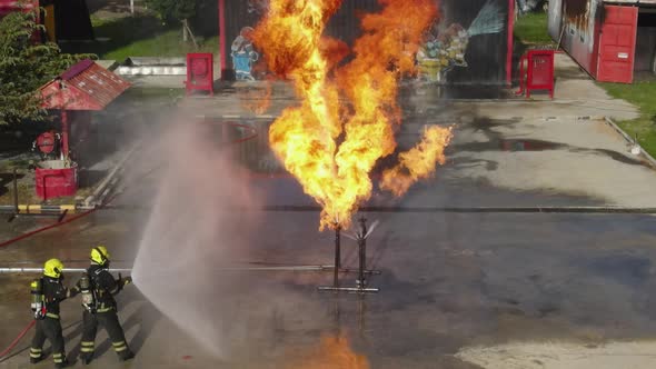Top and side view the fireman team practice to use sprinkler extinguish fire from gas pipe alt