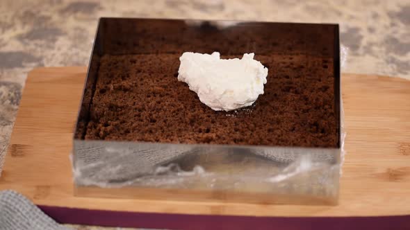 Woman Is Preparing Chocolate Cake with Milk Cream. The Process of Making the Chocolate Cake alt