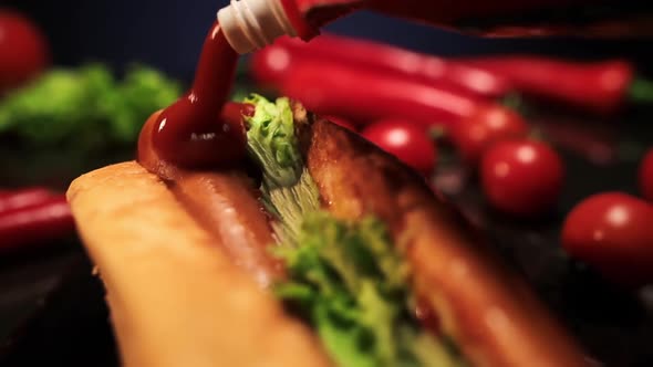 Ketchup pouring on a Hot Dog with sausage