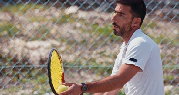 Slow motion of a tennis player serving the ball during a tennis game alt