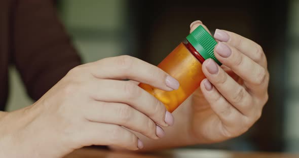 A Woman Holds a Jar of Medicine alt