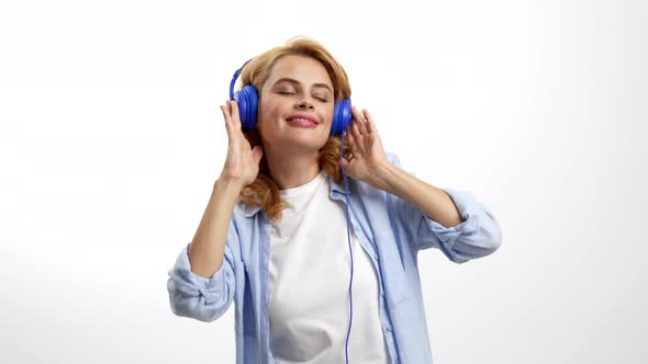 Cheerful Woman Dancing to Sensual Music Song in Earphones Enjoyment alt