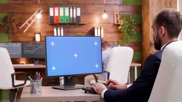 Bearded Businessman in Office Typing on Green Screen PC alt