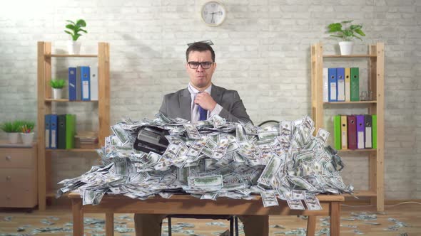 Portrait Serious Man Businessman in a Pile of Banknotes Looks at the Camera alt