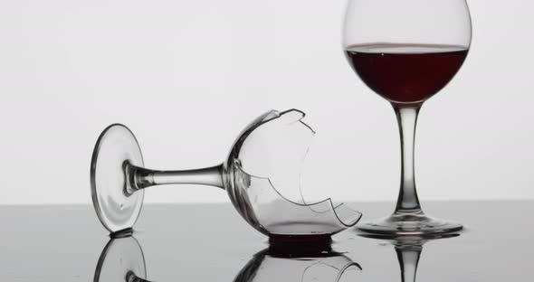 Detail Shot of Broken Wine Glass Which Is Laying on the Wet Surface alt