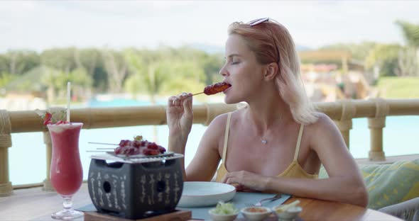 Delighted Woman Eating on Cafe Terrace alt
