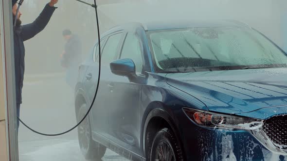 Dirty Car Cleaning And Protection With Active Foam. Clean Water Spray Pressure. Man Washing Car. alt