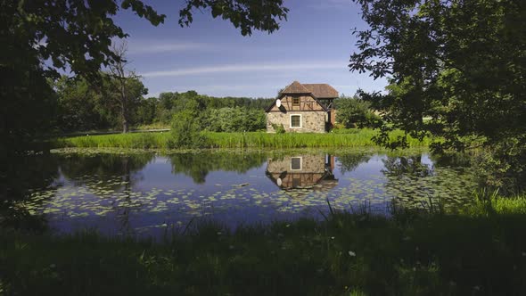 Rural Stone House By the Pond in Summer