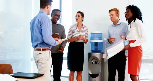 Executives discussing over digital tablet alt