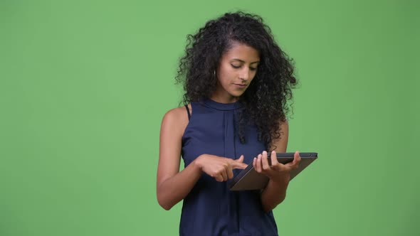 Young Beautiful Hispanic Businesswoman Using Digital Tablet alt