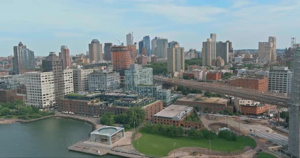 Flying backward view of across Brooklyn Bridge through the East river to Bridge district U.S. alt