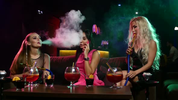 Young Sexy Womans Smoking the Hookah in Vintage Interior alt