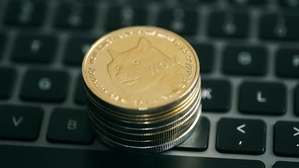 Golden Dogecoin is Rotating on a Keyboard Background