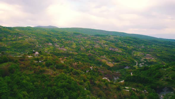 Scenic Drone Shot of Green Fields and Hills in Georgia alt