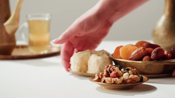 Turkish Tea and Sweets Hot Drink in Traditional Armudu Glass Closeup alt