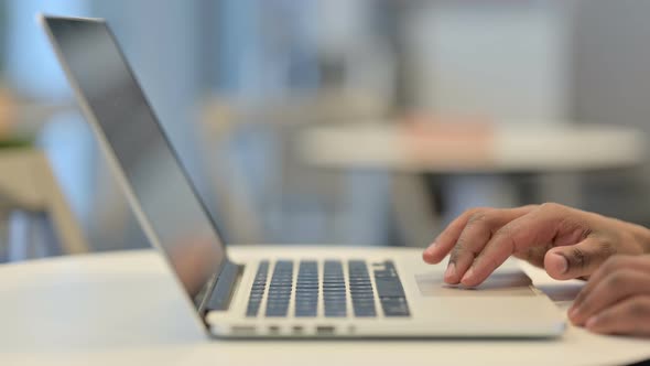 Hands of African Man Using Laptop Cursor Close Up alt
