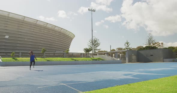 Mixed race athlete throwing javelin alt