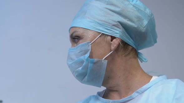 Exhausted Woman Doctor Looking at Patient After Complicated Surgery Therapy, POV