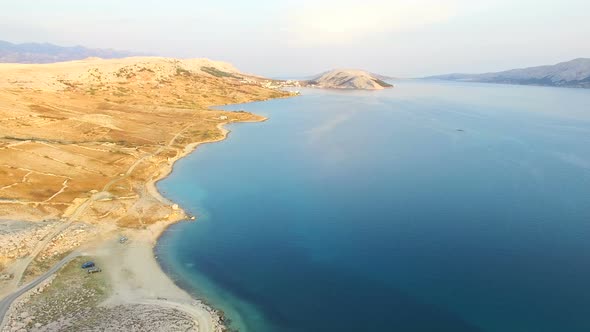Aerial view of turquoise sea and yellow grass of Pag island, Croatia alt