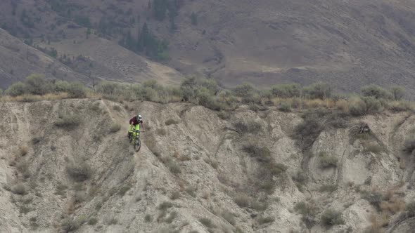 Two men riding mountain bikes. alt