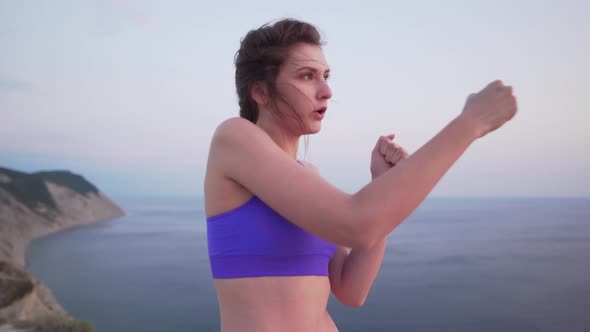 Beautiful Girl Athlete in Bra on the Background of the Sea Boxing Without Gloves. Fitness, Healthy