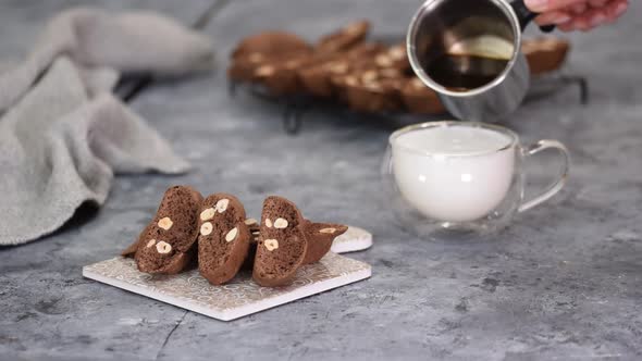 Close Up of Homemade Chocolate and Hazelnuts Cookies with Cup of Latte