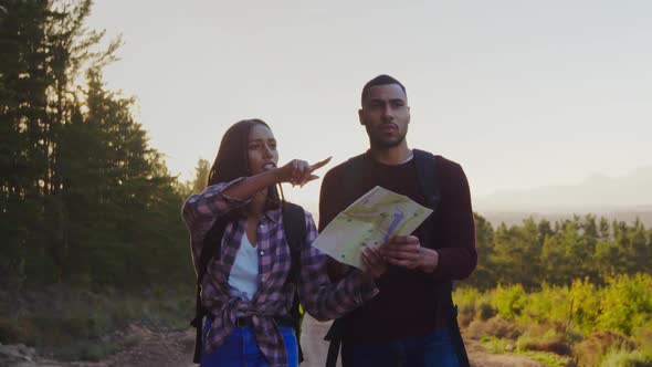 Young couple on a trek in countryside alt