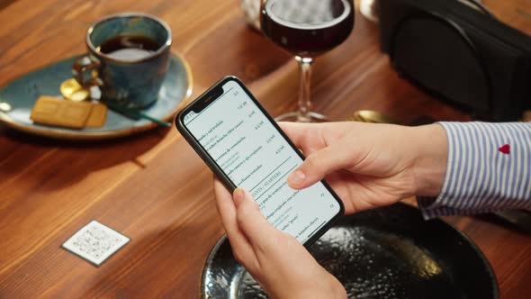 Woman Using Online Menu in Cafe Scanning Qr Code with Smartphone in Restaurant alt